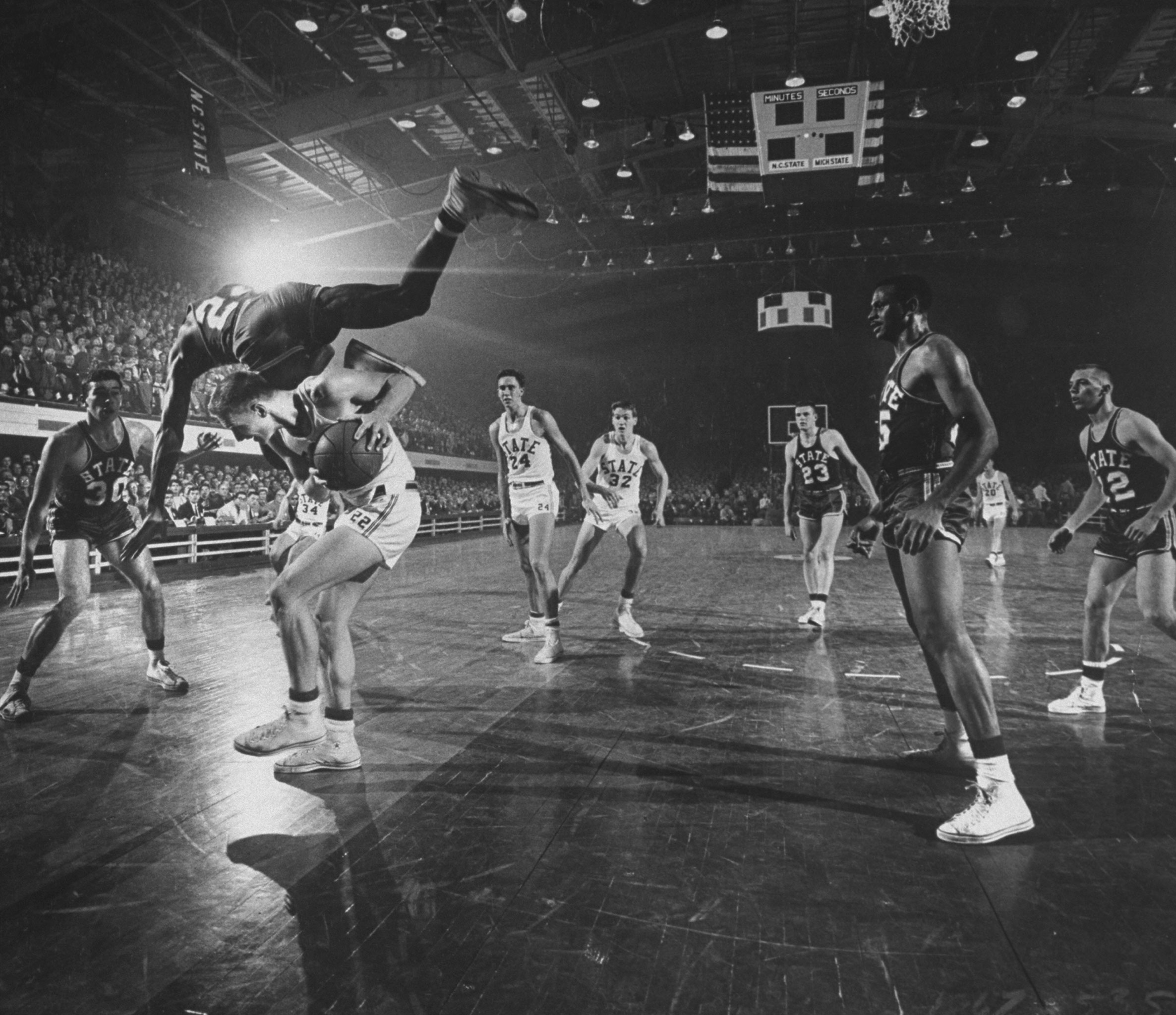 In the eight-team 1958 Dixie Classic, the Michigan State Spartans (in the dark uniforms) made it all the way to the final before falling to host North Carolina State (in white). At the end of the season, N.C. State was ranked sixth and Michigan State seventh in the final AP poll.